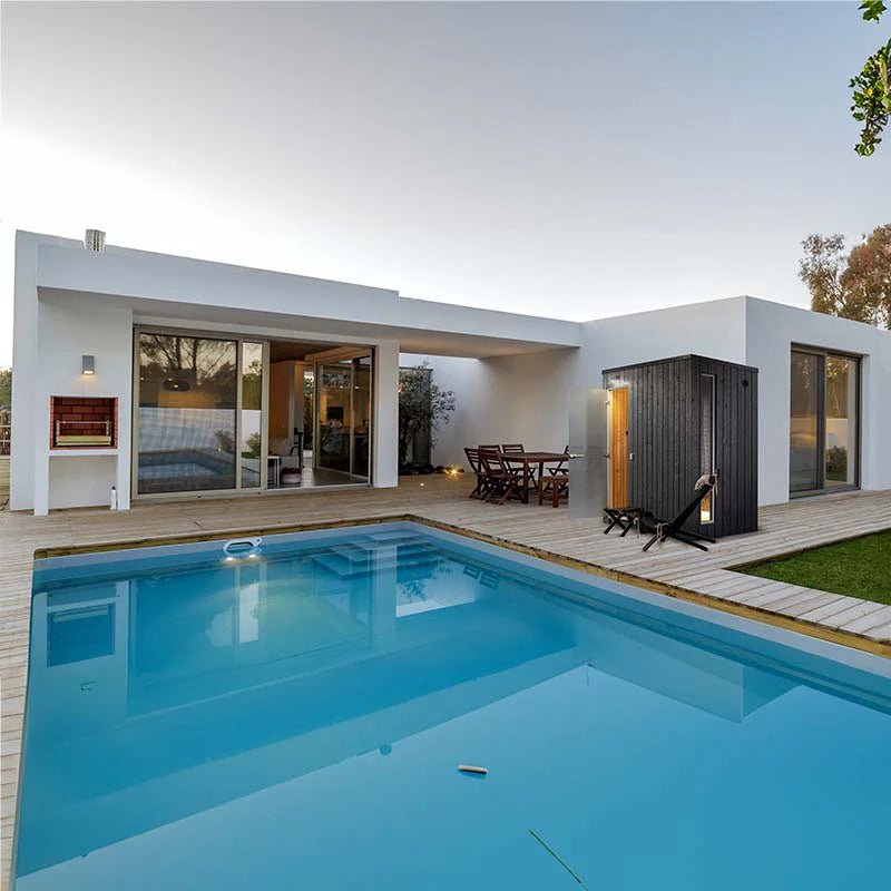 Mist outdoor Turkish bath with swimming pool and house in the background.