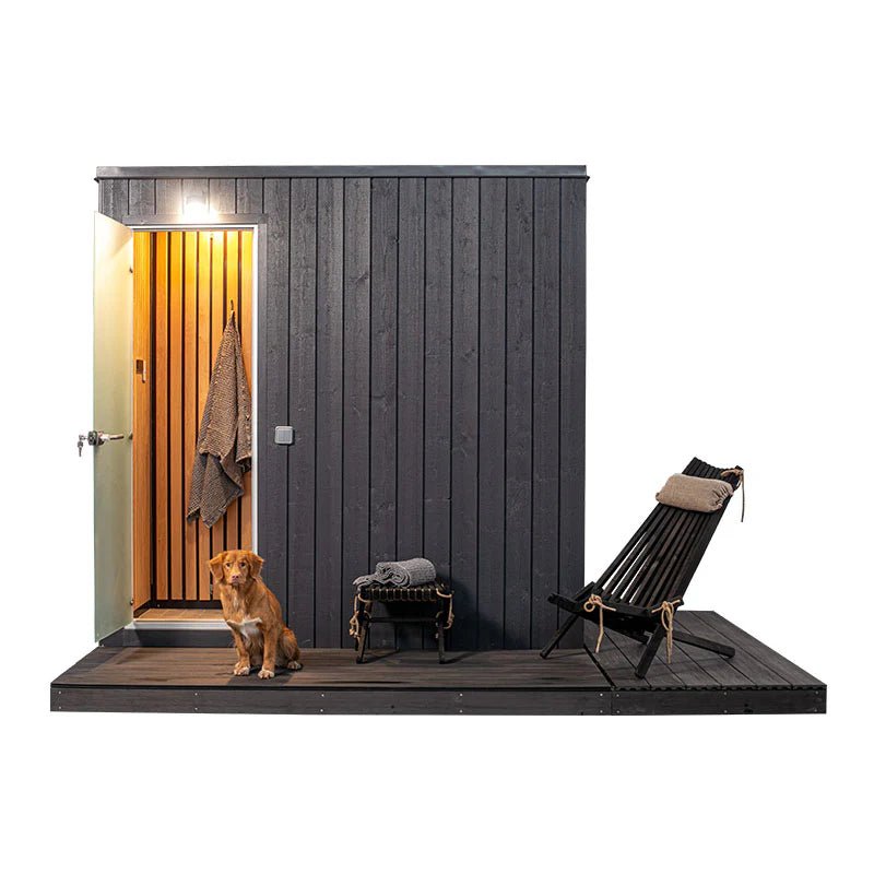 Mist outdoor Turkish bath with chair and dog next to it.