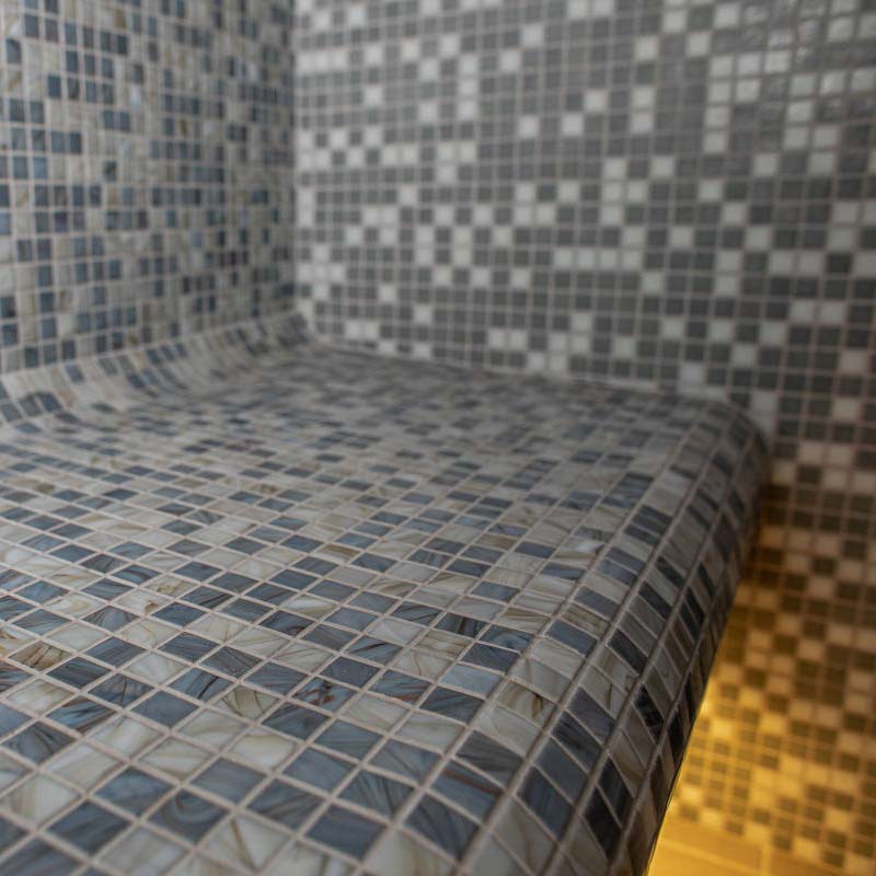 Mist outdoor Turkish bath with tiled bench in the shower.
