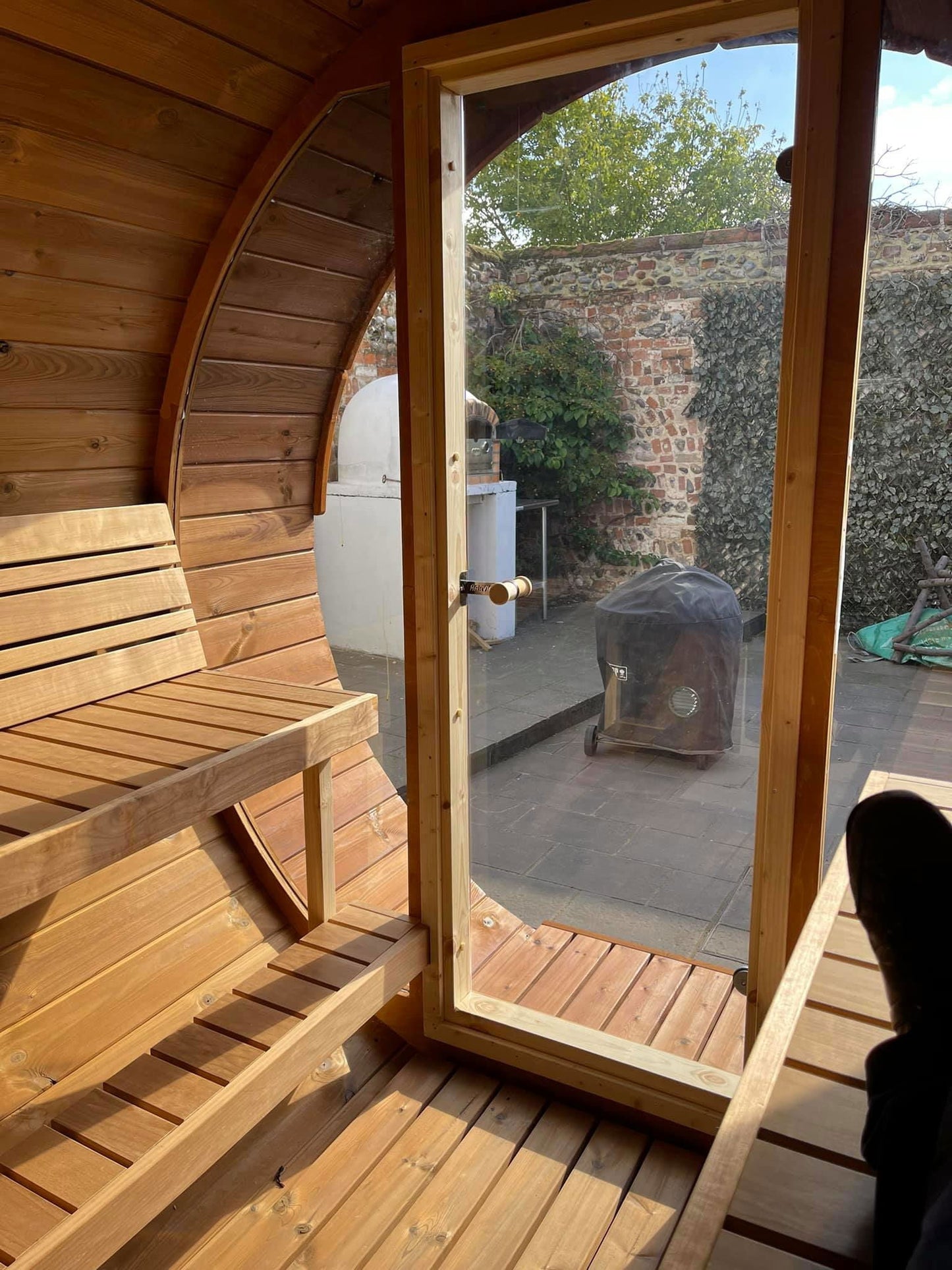 Sauna Barrel 280 Deluxe with wooden barrel bench.