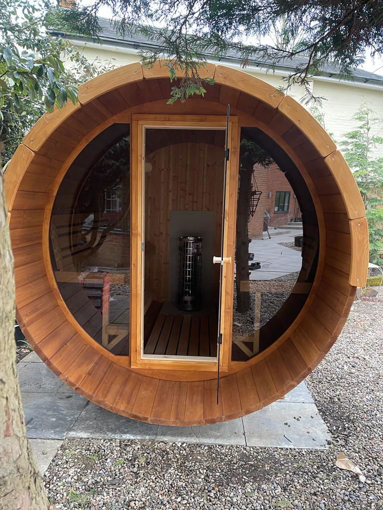 Sauna Barrel 280 Deluxe with glass front and terrace.