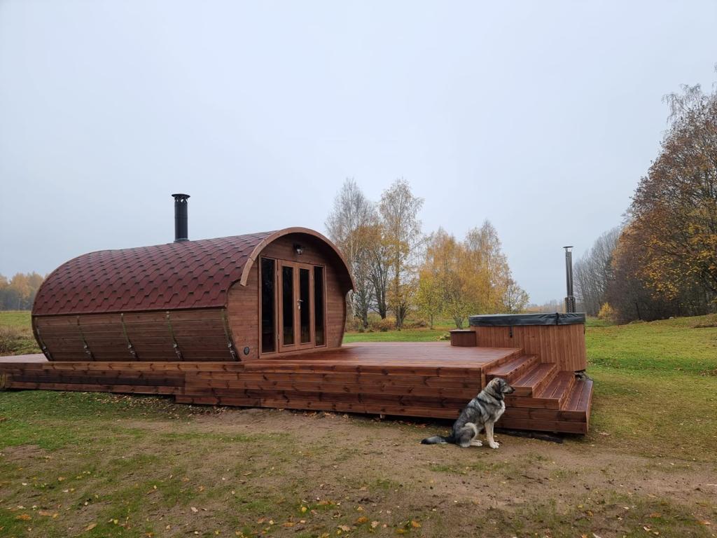 Hobbit 500 outdoor sauna next to wooden deck.