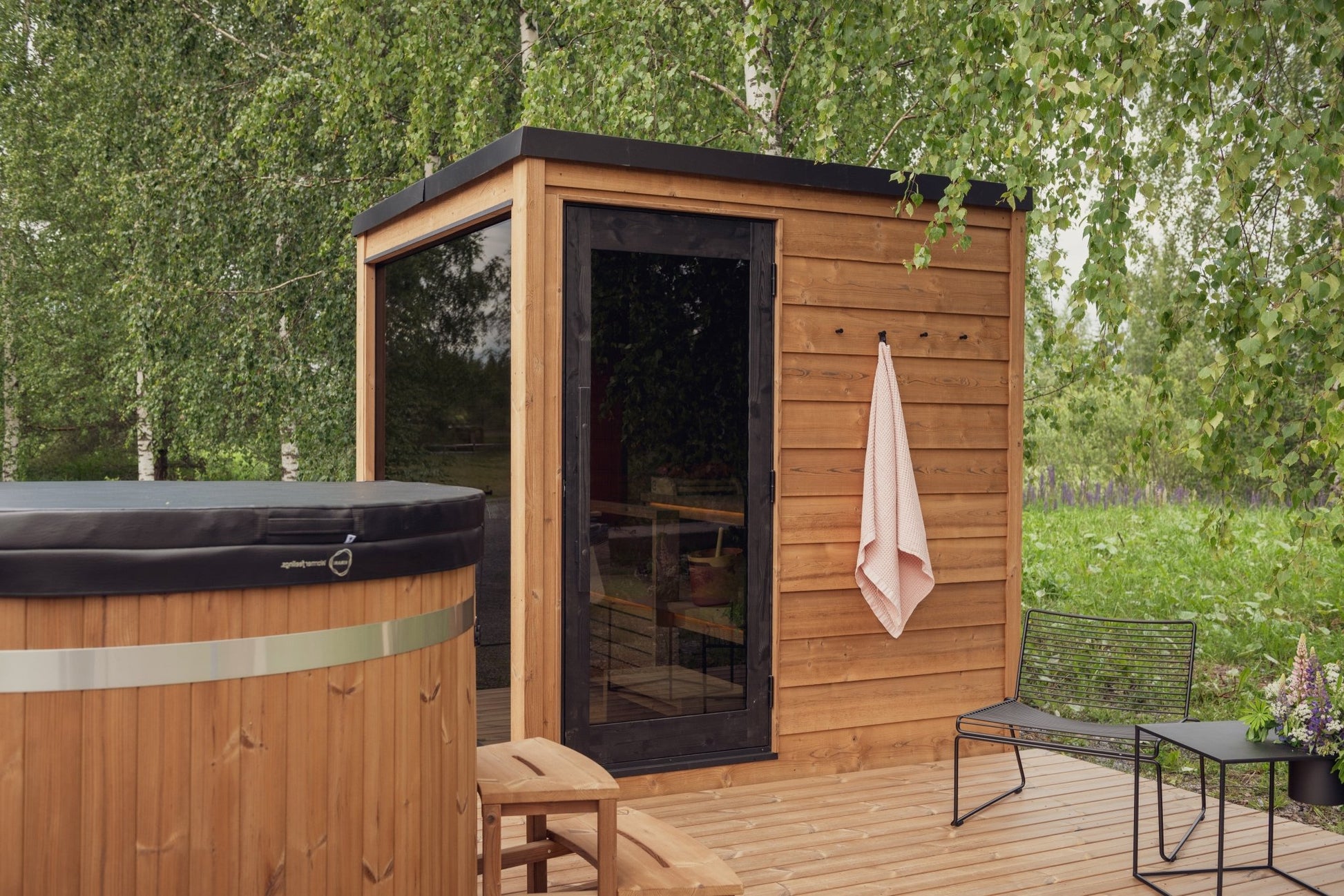Nordic Dawn outdoor sauna pre-assembled in a natural environment.