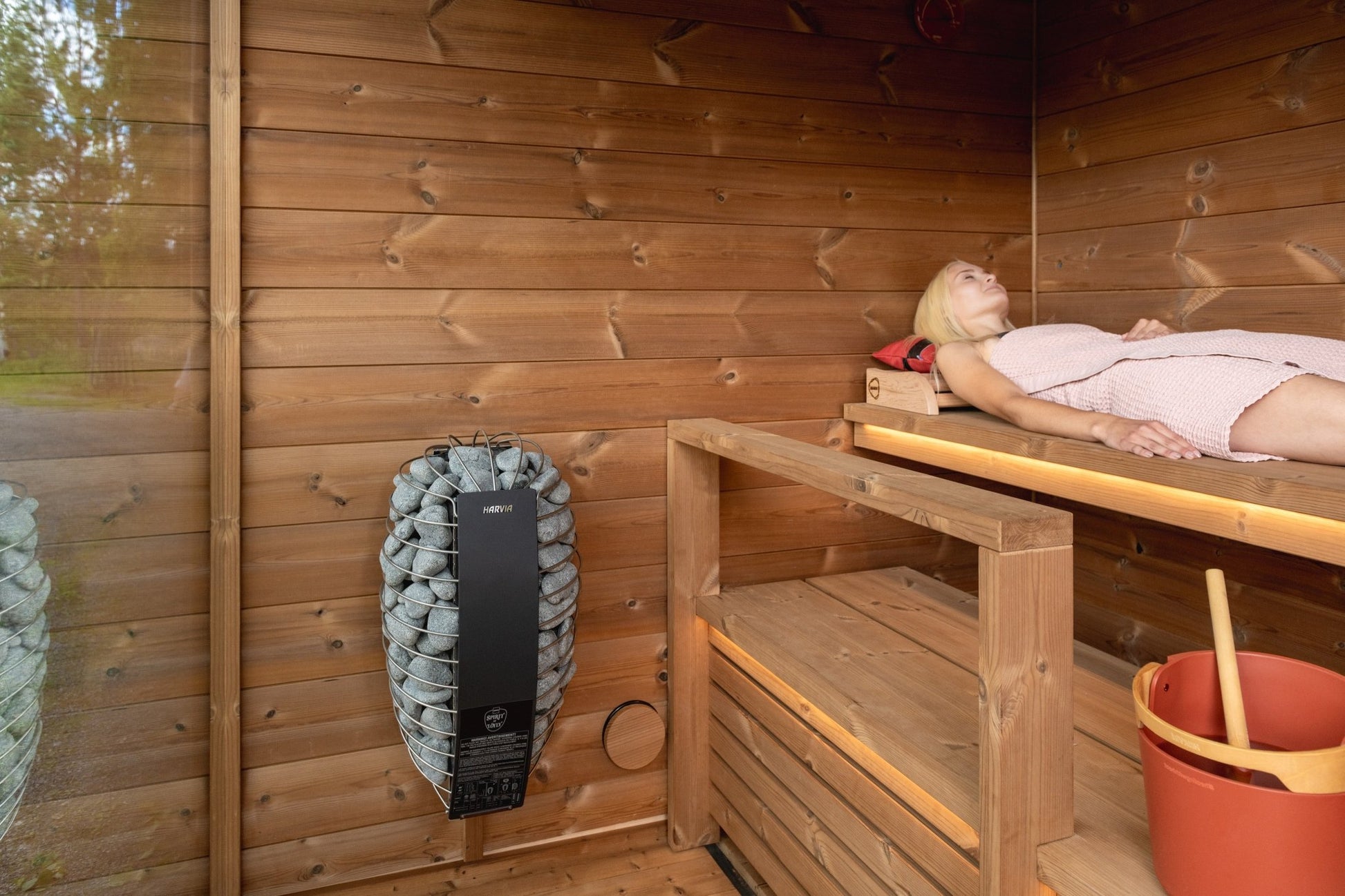 Nordic Dawn outdoor sauna for use in a wooden environment.