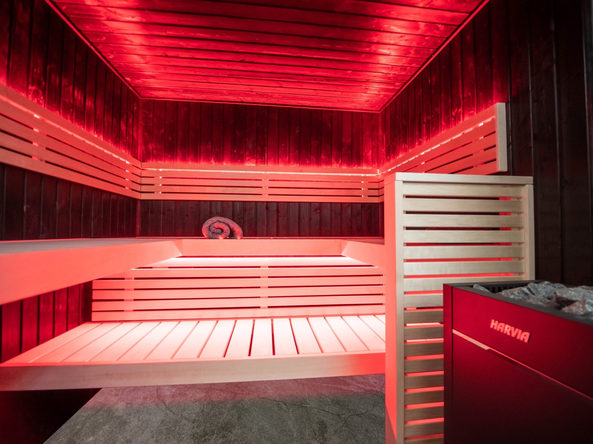 Fenix sauna with red lights and light wood benches.