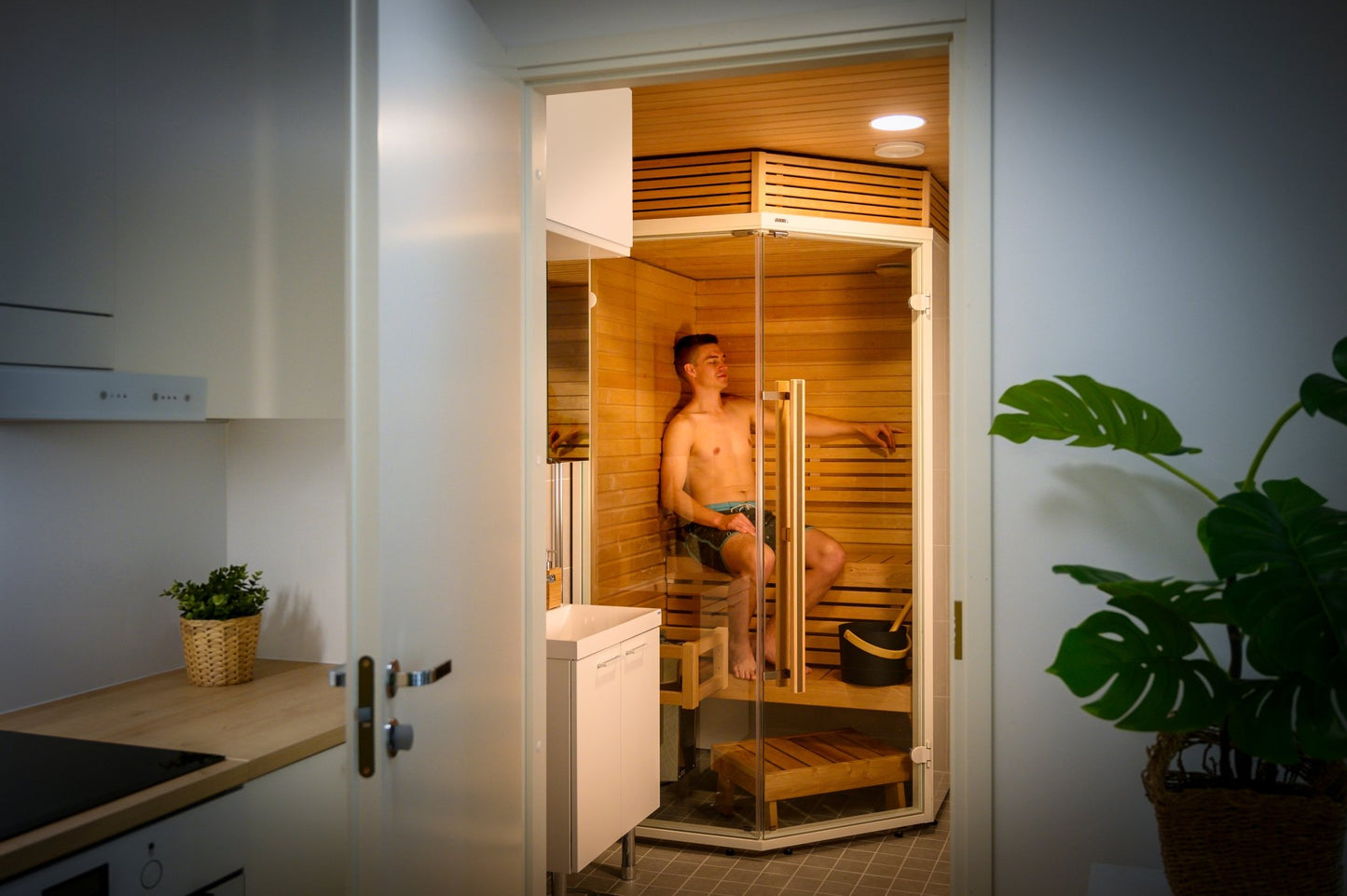 Sirius Corner sauna with man relaxing.