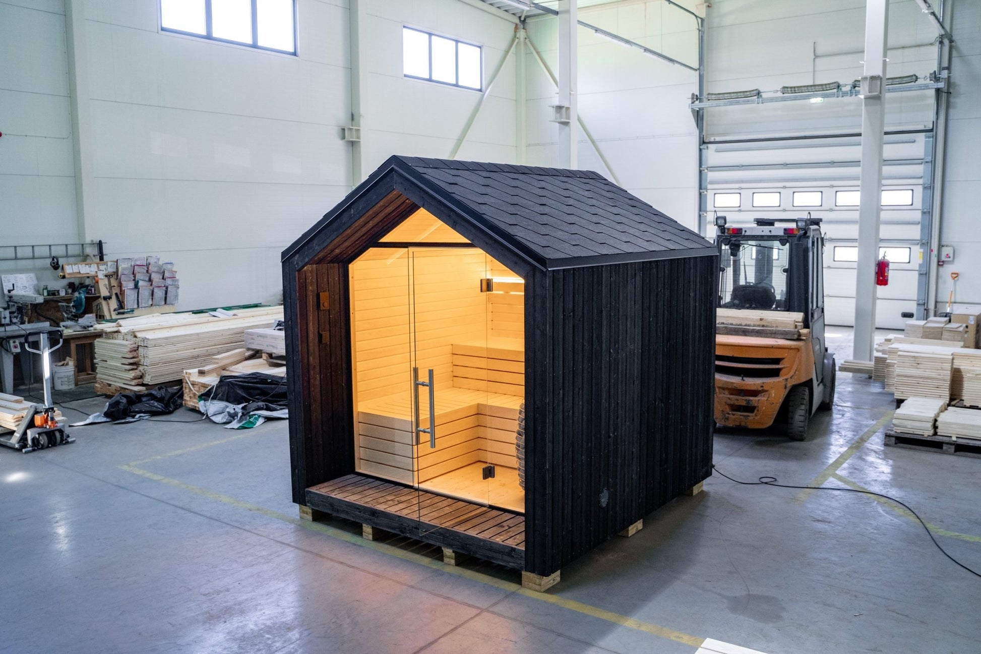 Lumi outdoor sauna with glass door and internal light.
