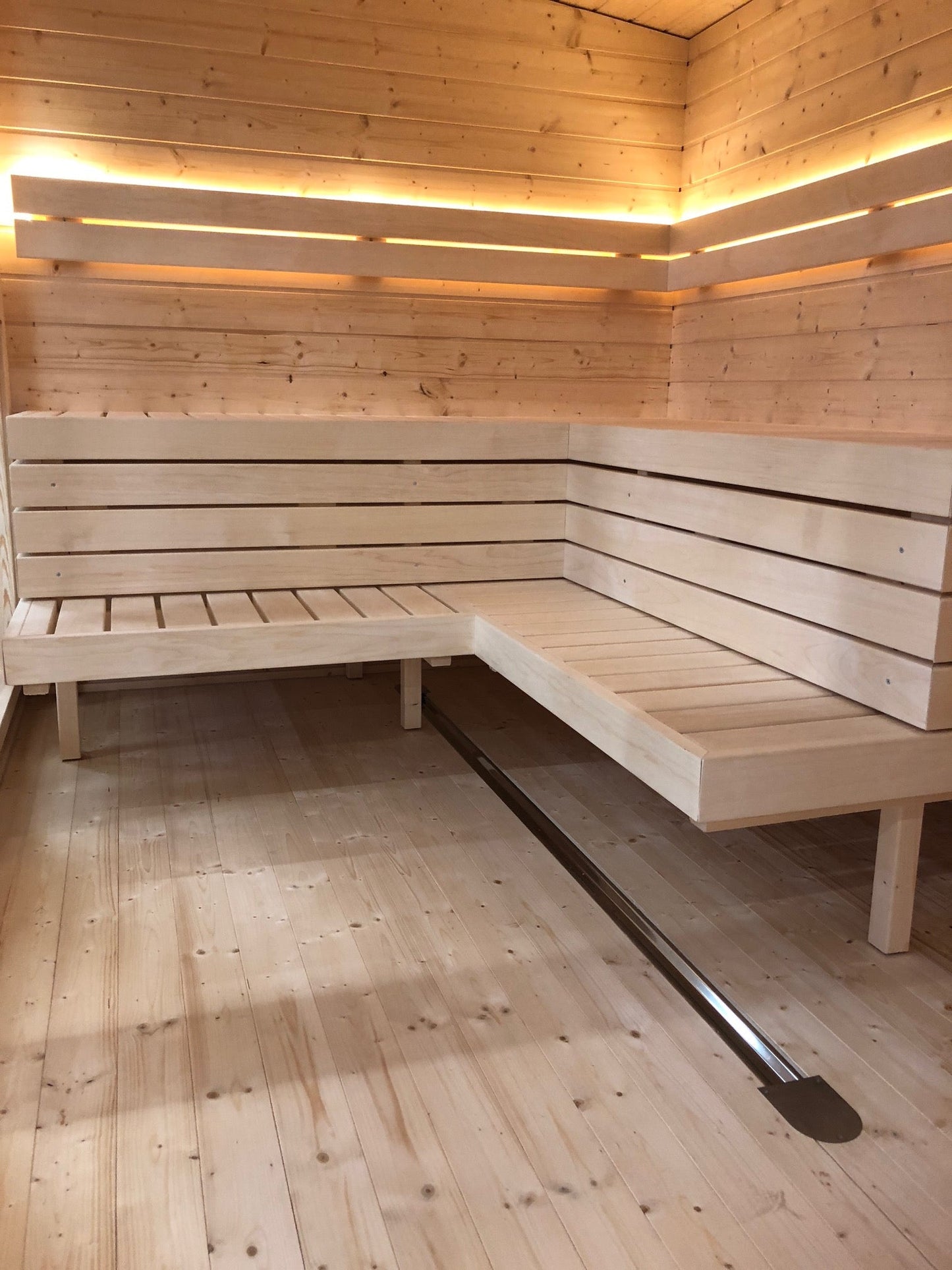 Modular outdoor sauna with wooden bench.