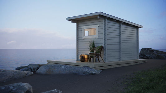 Sauna exterior Saunamo Nordica na praia com cadeira e planta.