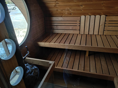 Hobbit 300 outdoor sauna with benches and table.