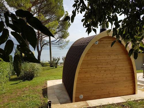 Pod outdoor sauna with chimney and wooden structure.