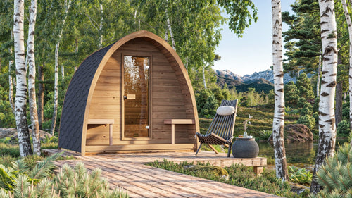 Outdoor Sauna Pod with chair and table on deck by the lake.