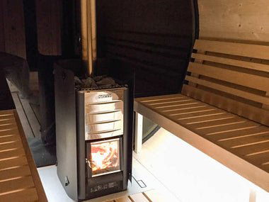 Outdoor sauna Barrel 250 next to a wood-burning stove.